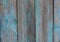 Old wooden fence with blue shabby paint