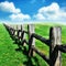 Old wooden fence at green field