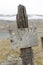 Old wooden fence post and rustic sign