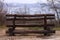 An old wooden footbridge over a ravine in the autumn foggy forest. Empty park near the river. Street travel wallpaper