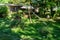 Old wooden fountain with balance in a green garden park