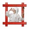 Old wooden frame against a white background with a young boy dressed as chef with wooden spoon on white background.