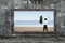 Old wooden frame window sea view with cheering man