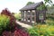 Old Wooden Garden Shed Near Horse Pasture in Lush Summer Cottage Garden