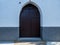 Old wooden gate fixed with large brass rivets in Cordoba, Andalusia, Spain