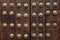 Old wooden gate fixed with large brass rivets in Cordoba, Spain