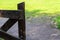 Old wooden gate pasture open passage and farm on background of sunny meadow base rustic design