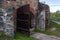 Old wooden gate to the stone watchtower