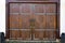 Old wooden gates on wrought-iron curtains