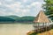 Old wooden gazebo with thatched roof on a river in the nature near the temple of truth