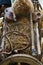 Old wooden handcart full of straw and agricultural tools