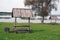 Old wooden handmade bench with roof near lake for tourists