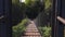 Old wooden hanging cable bridge in countryside in sunny morning