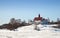 Old wooden house on the coast of frozen Gulf of Fi