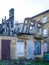 Old wooden house after the fire, dangerously collapsed wall