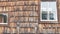 Old wooden house with glass windows. Beautiful vintage Austrian house with rotten old tree