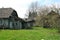 An old wooden house, a house made of wooden boards, a window, rural buildings, a village, an old well