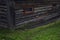 An old wooden house with metal bars on small windows. Close-up. Home prison