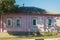 Old wooden house, painted pink, under old slate roof