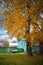 Old wooden house in the village, trees, countryside landscape in autumn