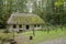 Old wooden house, white with a thatched roof covered with moss , wallpaper