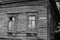 Old wooden house with windows, dilapidated housing