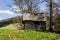 Old wooden hut cabin in mountain alps at rural fall landscape