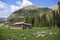 Old wooden hut cabin in mountain at rural fall landscape