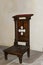 Old wooden kneeler  or prayer stool in a catholic church