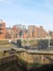 Old wooden lock gates on the canal in leeds city center surrounded by waterside apartment buildings