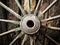 Old wooden metal wheel on the old wooden wall background