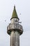 Old wooden minaret on sky background.