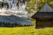 Old wooden mountain chalet and evening mountain ridge