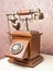 Old wooden phone. Vintage wooden telephone on white table. Retro