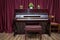 Old wooden piano keys on wooden musical instrument in front view . modern red piano bench . Big brown wooden piano and red bench