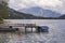 Old wooden pier with boats on Alpine lake Mondsee