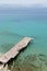 Old wooden pier on a greek turquoise sea