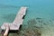 Old wooden pier on a greek turquoise sea