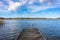 Old wooden pier or jetty for yachts and boats. Autumn landscape of the coast of Sweden. Forest islands with colorful trees in the