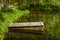 Old wooden pier on lake pond in summer