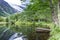 Old wooden pier on lake pond in summer