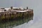 Old wooden pier reflected in water