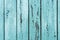 Old wooden planks with cracked peeling blue paint. Painted texture background. Rustic background