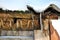 Old wooden planks wall of henhouse with rusty nails covered with white snow on roof and icicle