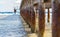 Old wooden poles under a pier or jetty