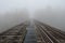 Old wooden railway bridge in foggy mist