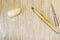 Old wooden rolling pin a piece of dough and a knife on wooden background