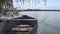 Old wooden rowing boat floating on the water on the river bank on a beautiful summer sunny day