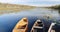 Old wooden rowing fishing boats moored near lake or river coast in beautiful autumn sunny day