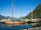 Old wooden sailboats are in the marina in Andalsnes, Norway